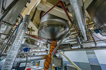 Stainless vertical steel tanks and pipes with pressure meter in equipment tank chemical cellar at the with stainless steel
