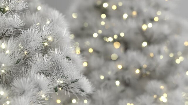Close-up of elegant white Christmas tree branches decorated with warm glowing lights, for a soft, festive, and wintry holiday atmosphere. Seamless loop background. Created using non-AI 3d software