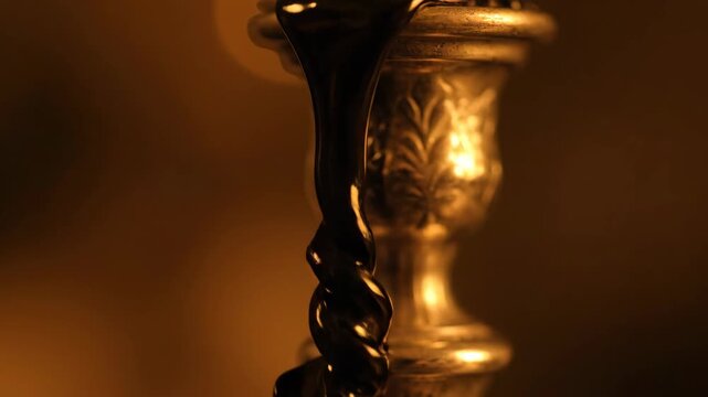 Molten substance drips from a vintage metal candlestick holder