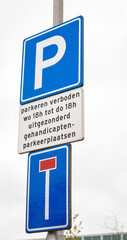 Bicycle path with dead end road sign with bicycle exception. Environment is a Dutch or Frisian landscape