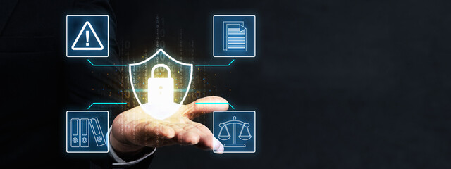 Businessman hand displaying a shield with a padlock in a digital. Surrounding the shield are icons representing security, documents, warnings, and legal balance. Concept of Data Privacy Enforcement