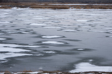 Melted ice on river in early spring. Early spring.