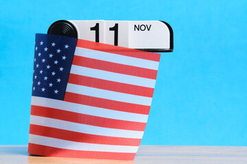 November 11 is Veterans Day. Calendar is wrapped with flag United States America. Space for text.