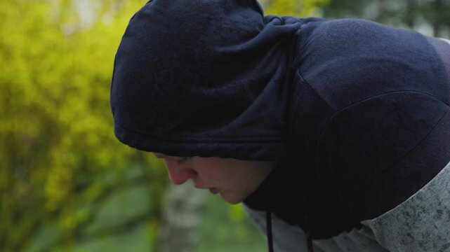 Pushing Limits Exhausted Male Athlete After Intense Outdoor Workout in the Rain