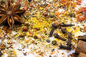 Assortment of oriental spices scattered on a white background. Top view. © Andrii
