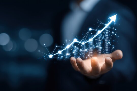 Hand holding glowing digital upward trending graph and arrow.