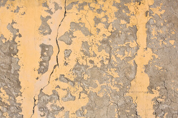 AGED, DETERIORATED, AND MOISTURE-COMPROMISED CEMENT PLASTER delaminating from the masonry substrate