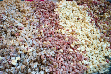 A colorful close-up showcases a variety of Turkish delight, arranged in colorful piles, appetizing and sweet.