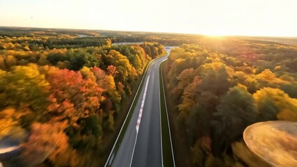 Experience the thrill of autumn racing with this dynamic aerial view of a track winding through vibrant fall foliage