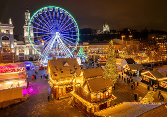 Aerial view of the Christmas market and Ferris wheel in Kyiv, Ukraine at night.