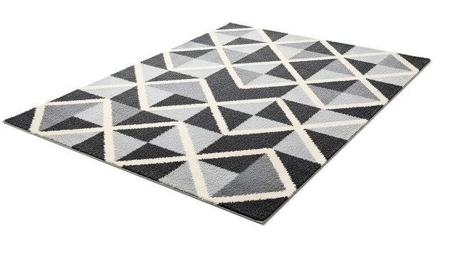 Angled shot of a geometric pattern rug in monochrome shades over a white backdrop