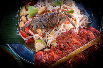 A vibrant Thai Som Tum with rice noodles presented in a rustic still life setting. Fresh vegetables, bold spices, and authentic textures ideal for food concepts, menus, culture, and culinary visuals.