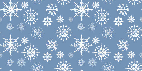 Bright seamless pattern of white snowflakes in various shapes and sizes on light blue background, ideal for winter decorations, textiles, and festive prints