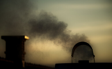 Smoke from the chimney. Typical contribution to air pollution from an individual heating device running on oil.