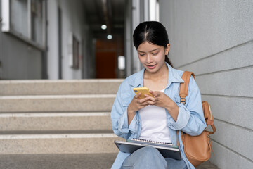 Portrait beautiful Asian woman student. Smile girl happy study. Use phone read ebook in college campus. young female on international Asia University. Education, study, school, learning, exam