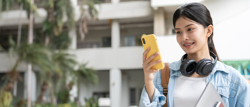 Portrait beautiful Asian woman student. Smile girl happy study. Use phone read ebook in college campus. young female on international Asia University. Education, study, school, learning, exam - Powered by Adobe