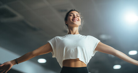 Smiling woman enjoying her workout in a spacious gym at dawn