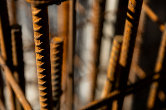 Close-up of rusted steel rebar used in reinforced concrete construction. The image shows the texture and structure of building materials on-site.