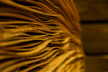 Close-up of thin wood veneer sheets stored in warehouse for manufacturing and industrial use.