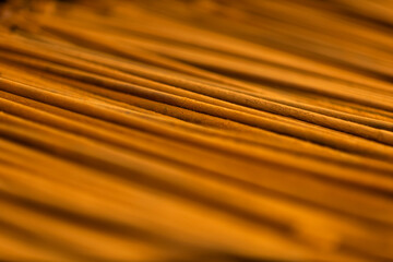 Violin bow Thin wooden sticks organized on a workbench for handcrafted production.