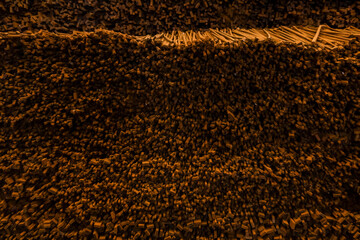 Violin bow Thin wooden sticks organized on a workbench for handcrafted production.