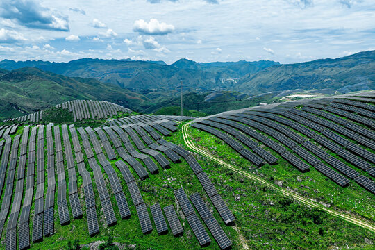 Solar panels on green grass hill generating renewable energy in the nature outdoor. - Powered by Adobe