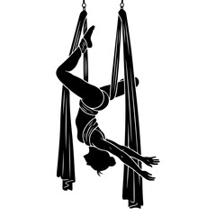Silhouette of a female acrobat performing aerial silks gymnastics.