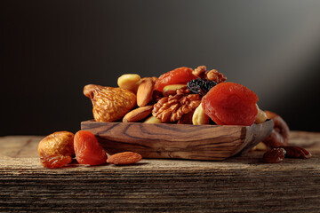 Dried fruits and nuts on a old wooden table.