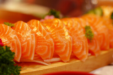 Several pieces of salmon sushi arranged as a set meal in a restaurant