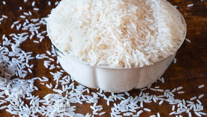 Close up of white rice overflowing from a decorative bowl