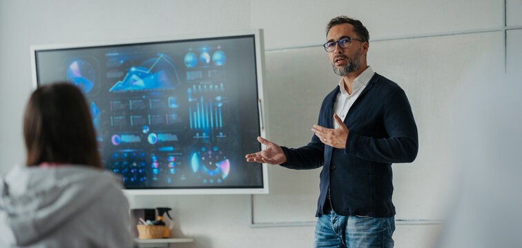 Teacher teaching in high school classroom.