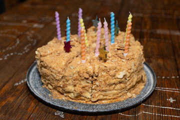 Cake divided into pieces with unlit candles.