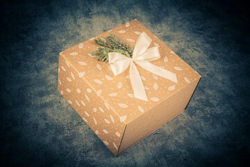 Gift box with bow on grunge background. Toned.