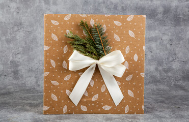 Gift box with christmas tree branch on grunge background.