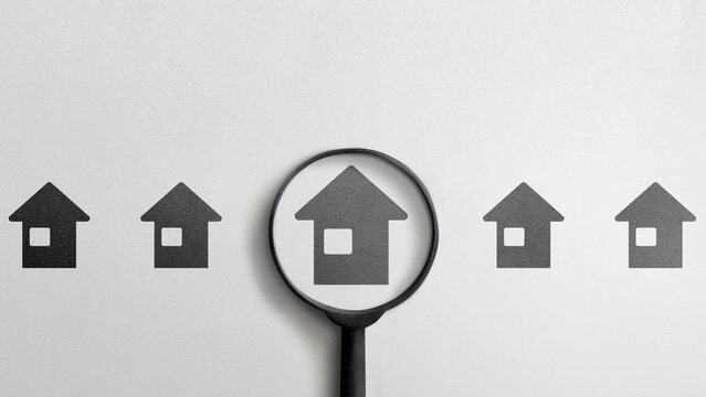 Row of house icons with one house highlighted by a magnifying glass, symbolizing house hunting and selection. Concept of Home Inspection