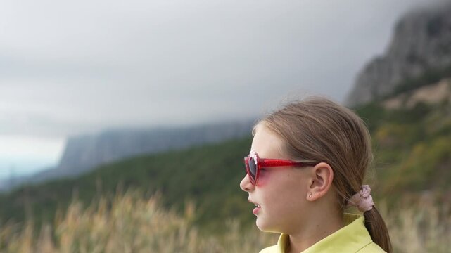 Girl, Portrait, Mountains: Young traveler in heart sunglasses enjoying the majestic landscape during a fall hike.