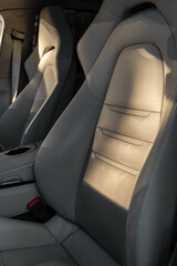 Beige leather sport car seats in sunlight