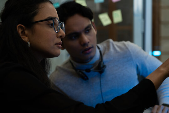 Customer support team in a modern call center receiving guidance from a supervisor. Diverse employees working with headsets and computers, representing teamwork, communication, and business 