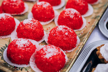 Fresh red velvet cupcakes arranged on a serving tray.