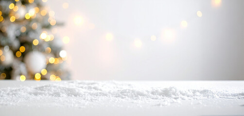 Warm and inviting festive backdrop with soft-focus golden lights, beautifully complementing a flat display of white fake snow for a cozy holiday atmosphere