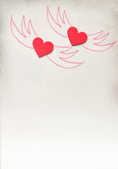 Creative sand texture with two wooden red heart and wings drawing on the sand. Valentine's Day and love background. Empty place (pattern card) for message. Flat lay. Mockup.