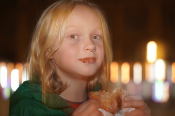 Naklejka premium Child Enjoying a Sugary Treat with Chocolate Smudges