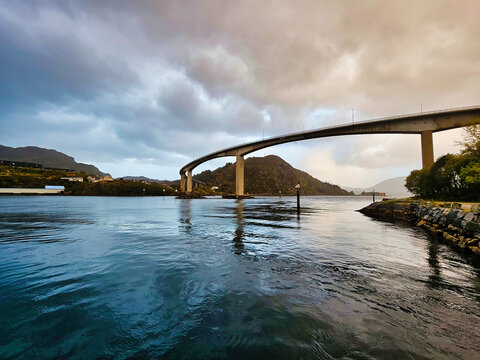 Dramatic view of the fjord landscape with a modern bridge in M&aring;l&oslash;y, Nordic sky.