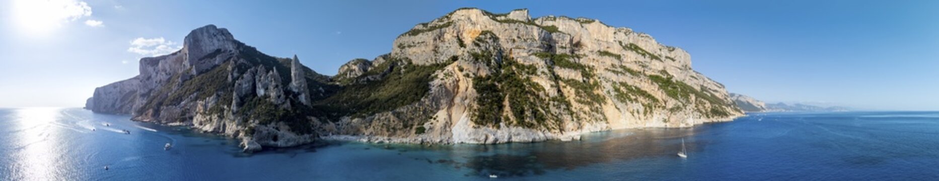 Panorama, picturesque rocky coast, cliffs with L'Aguglia pinnacle, blue sea and Cala Goloritz&eacute; beach, aerial view, Golfo di Orosei, Baunei, Sardinia, Italy