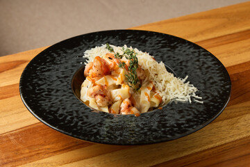 Gourmet shrimp and parmesan dish elegantly displayed against cozy wooden environment for refined ambiance