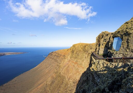 Panoramic window at the Mirador del R&iacute;o viewpoint, designed by artist C&eacute;sar Manrique, view of steep cliffs and sea in the evening light, Lanzarote, Canary Islands, Spain