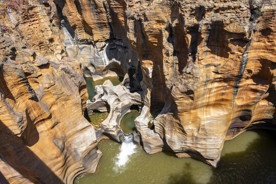 Eroded rock formations, canyon with steep orange-coloured rock cliffs with the Blyde River, Bourke's Luck Potholes, Panorama Route, Mpumalanga, South Africa