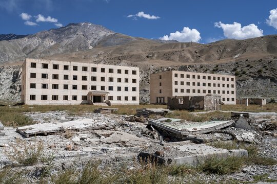 Abandoned, destroyed residential buildings, old Soviet apartment blocks in the ghost town, Engilchek, Tian Shan, Kyrgyzstan