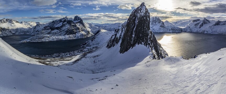Aerial view of Bergen by the sea, fjord, sunbeams, winter, snow, panorama, Mount Segla, Senja, Troms, Norway