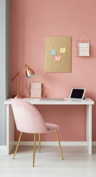 Stylish pink home office desk setup with gold accents